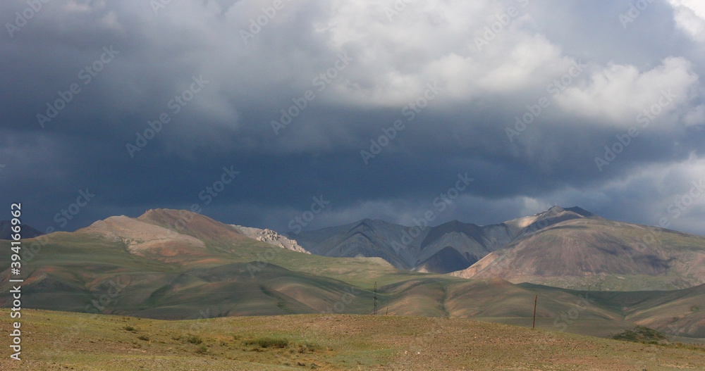 Landscapes of Mongolia. Desert mountain slopes and valleys. Mountain range on the background of the steppe. Photo with copy space.