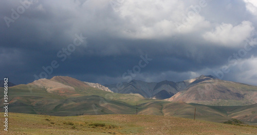Landscapes of Mongolia. Desert mountain slopes and valleys. Mountain range on the background of the steppe. Photo with copy space.