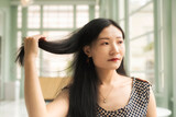 chinese woman holding her long hair