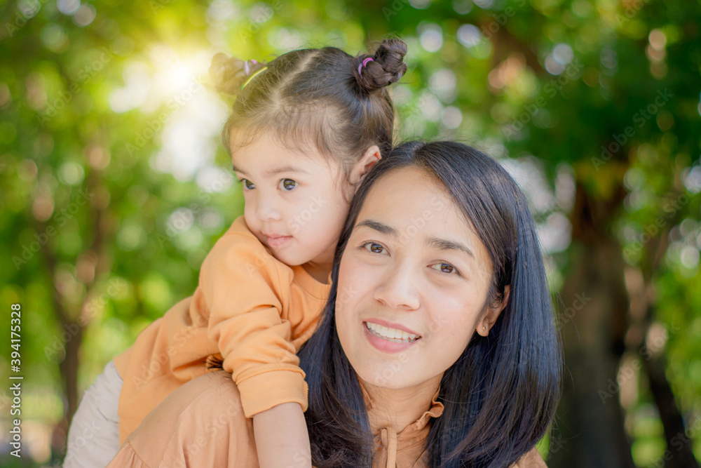 concept portrait lifestyle Asian beautiful mother and daughter cheerful child,hugging love and happiness,activity in family enjoy natural greenery park holiday,relax and learn to play outside together