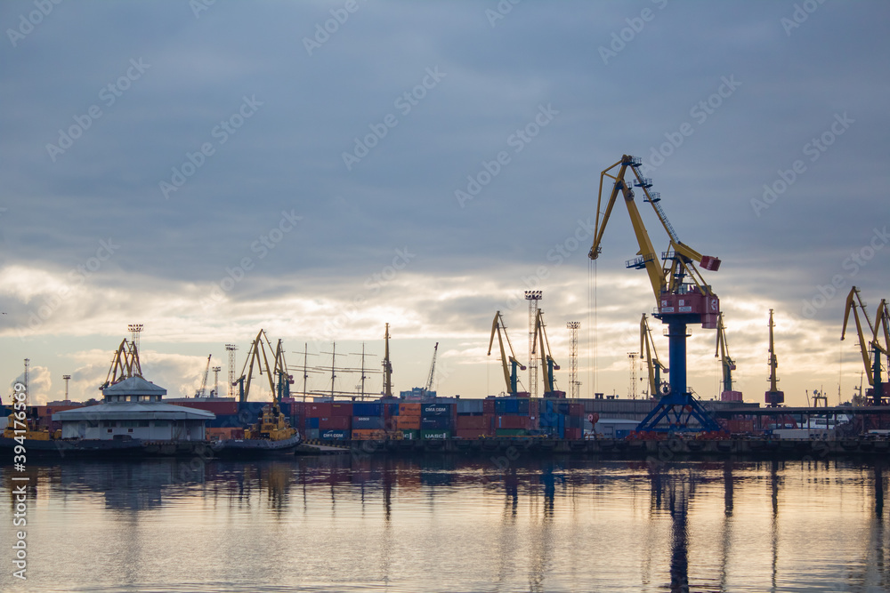 Fototapeta premium Lifting cranes and containers in the cargo port 