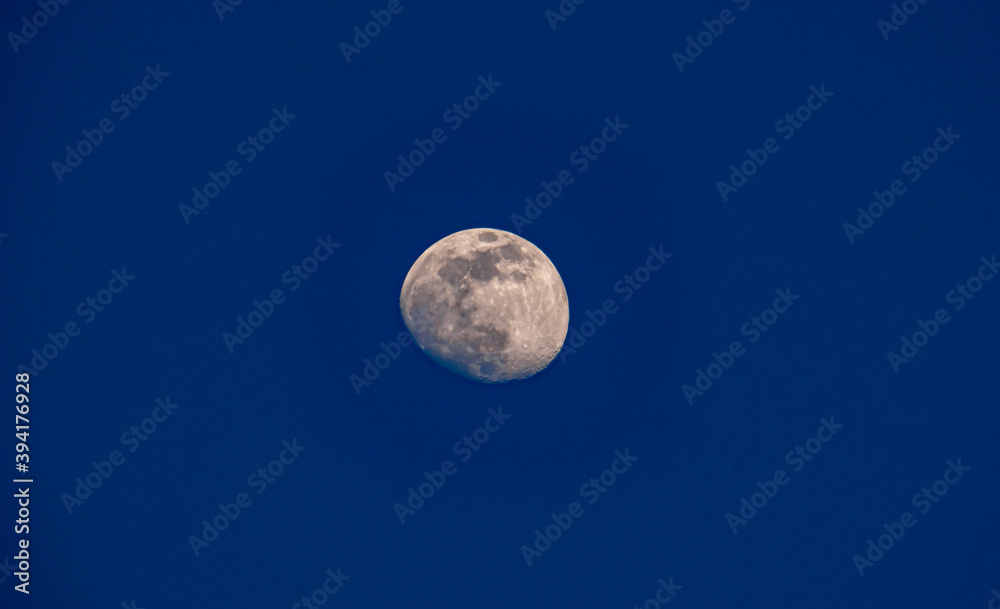 The full moon in the sky during the day