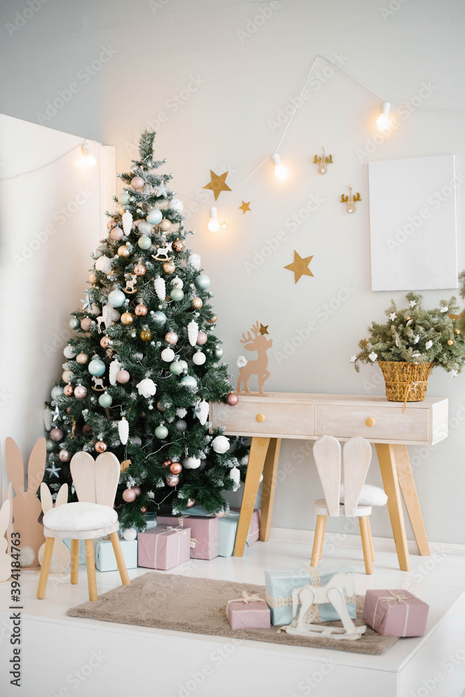Cozy bright children's room with a Christmas tree, chair and toys in a light color