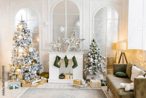 Bright cozy living room with a large elegant Christmas tree, decorated for Christmas