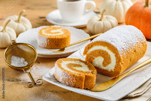 Pumpkin roll cake with cream cheese and tea. Autumn dessert. Selective focus.
