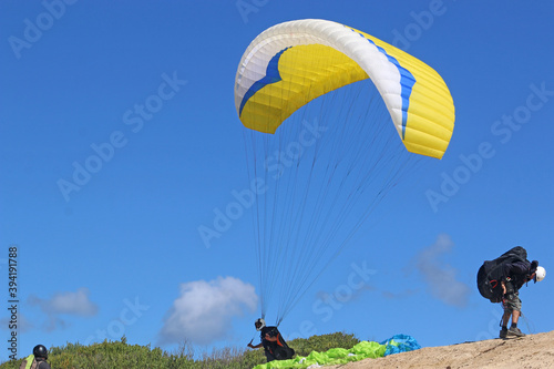 Paragliders launching above Victory Walls beach, Portugal