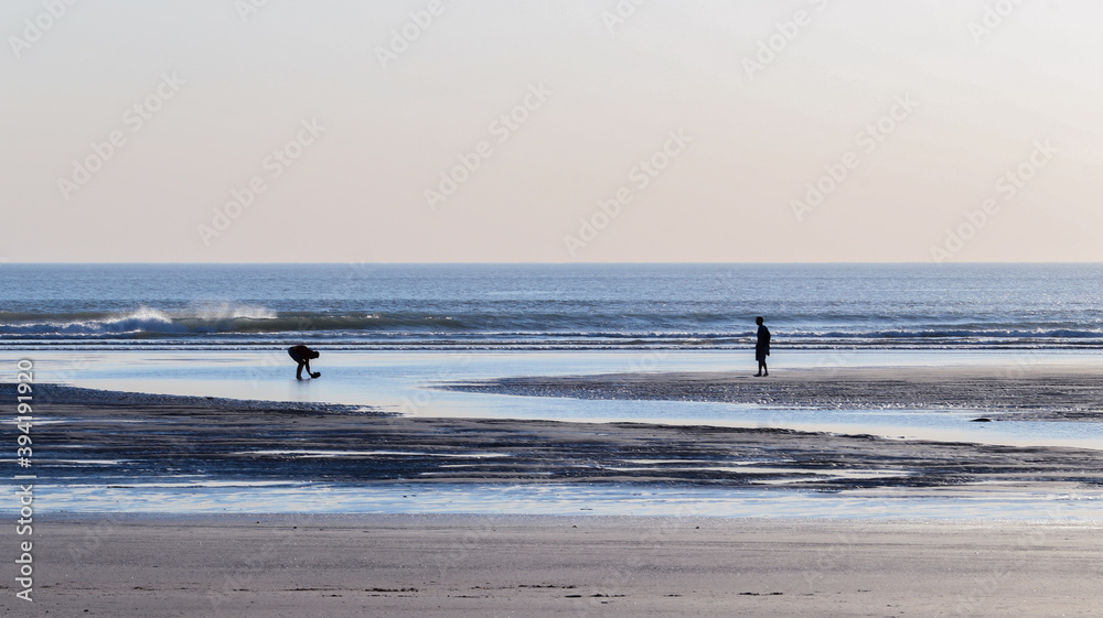 two people on a beach in Devon