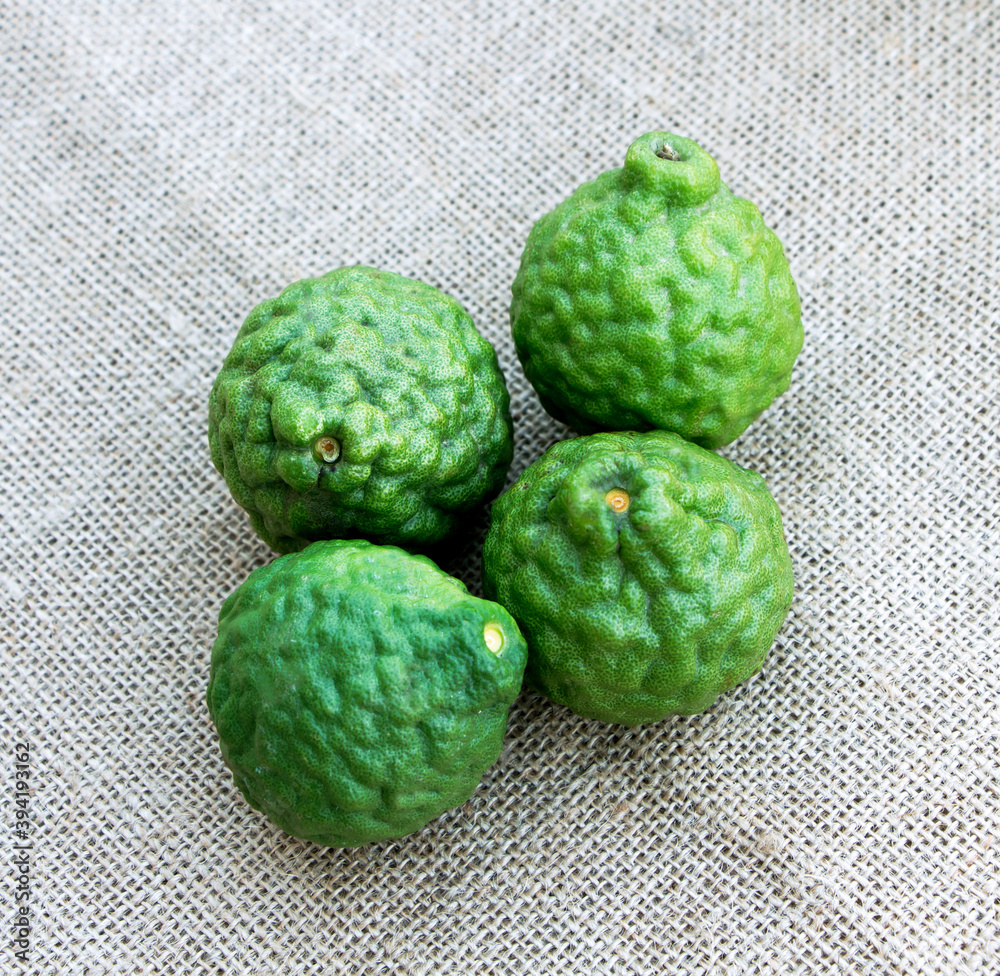 Obraz premium Bergamot fruit material of essential oils for beauty and cooking food ingredient healthy, it is on the sackcloth background.