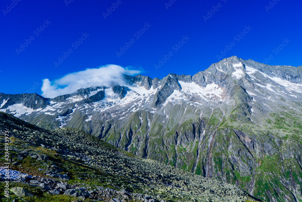 Panoramic view with sunrise on idyllic mountain backdrop in the Alps with fresh green meadows in summer Stange near Zillergrundl. Austria Zillertaler Alpen tirol