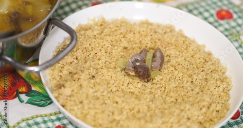 put couscous with chicken offal and turnips and turnip greens in the white plate, Berber dish 