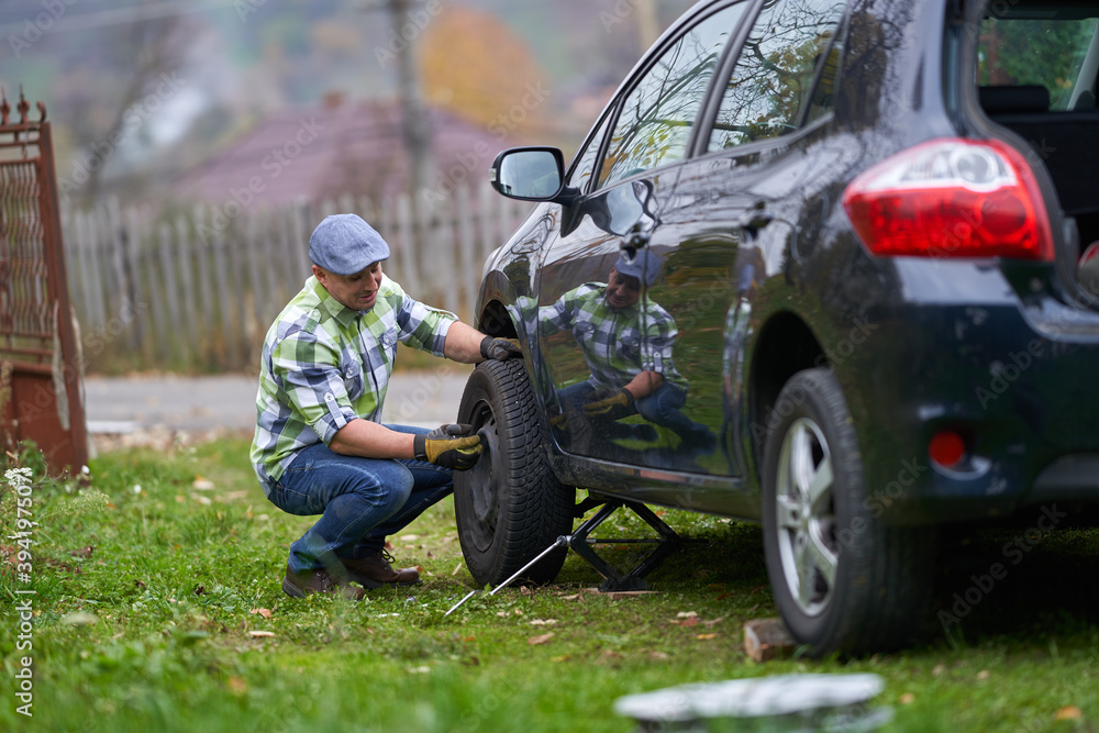 Man changing a flat tyre Man changing a flat tyre