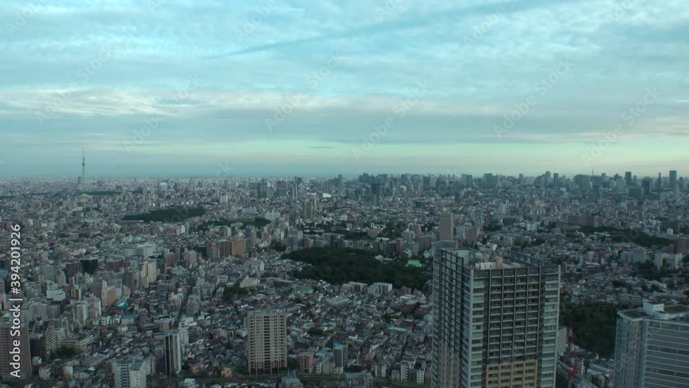 TOKYO, JAPAN : Aerial high angle sunset CITYSCAPE of TOKYO. View of buildings at central downtown area. Japanese city life and urban metropolis concept. Long time lapse zoom in shot dusk to night. TOKYO, JAPAN : Aerial high angle sunset CITYSCAPE of TOKYO. View of buildings at central downtown area. Japanese city life and urban metropolis concept. Long time lapse zoom in shot dusk to night.