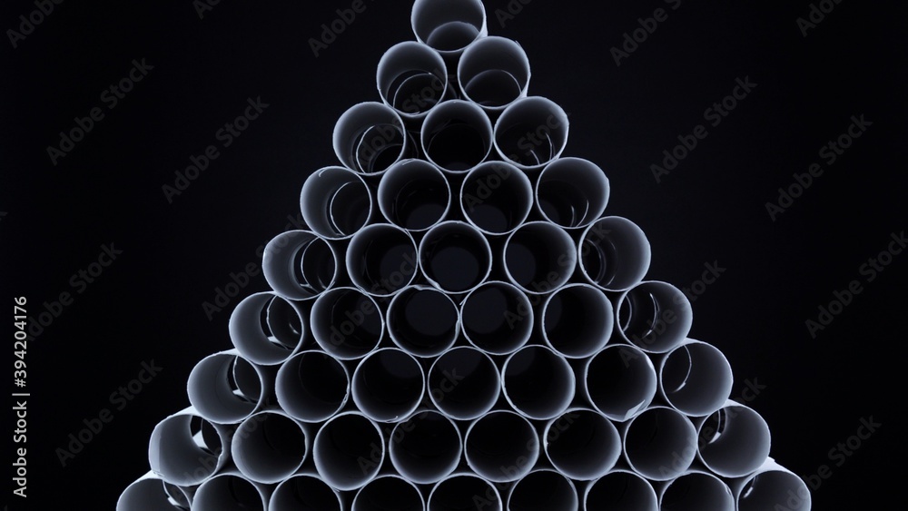 Empty toilet paper rolls on black background. Pyramid of hygiene items, empties toiletries exhausted during Covid-19 coronavirus epidemic lockdown. Empty stocks at quarantine and self-isolation. Empty toilet paper rolls on black background. Pyramid of hygiene items, empties toiletries exhausted during Covid-19 coronavirus epidemic lockdown. Empty stocks at quarantine and self-isolation.