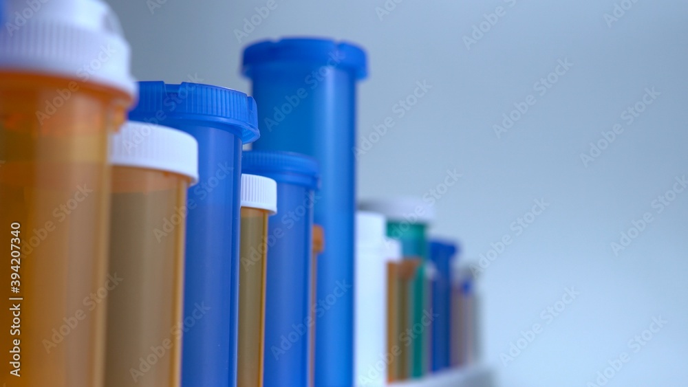 Various pills bottles macro close up shot. Production of medicines bottles. Pharmaceutical concept of healthcare, pharma industry, medication and drugs production. Medical research and trials. Various pills bottles macro close up shot. Production of medicines bottles. Pharmaceutical concept of healthcare, pharma industry, medication and drugs production. Medical research and trials.