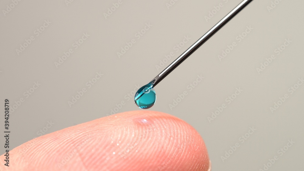 Medical vaccine dripping from the syringe needle. Concept of lab developing research of vaccine against Coronavirus, COVID-19. Pre-clinical evaluation and clinical phase trials development test Medical vaccine dripping from the syringe needle. Concept of lab developing research of vaccine against Coronavirus, COVID-19. Pre-clinical evaluation and clinical phase trials development test
