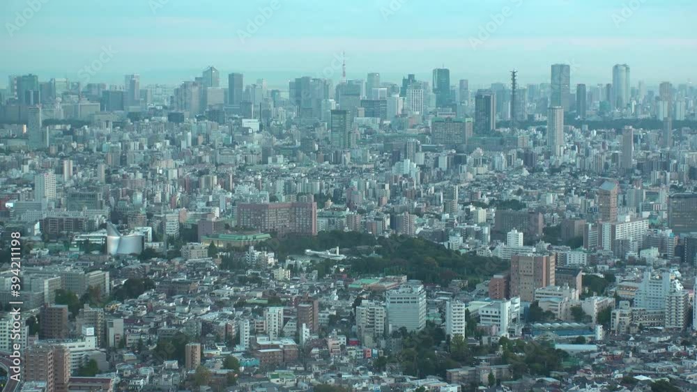 TOKYO, JAPAN : Aerial high angle sunset CITYSCAPE of TOKYO. View of buildings around Shinjuku and Minato ward. Japanese urban metropolis concept. Long time lapse zoom in shot sunset to night. TOKYO, JAPAN : Aerial high angle sunset CITYSCAPE of TOKYO. View of buildings around Shinjuku and Minato ward. Japanese urban metropolis concept. Long time lapse zoom in shot sunset to night.
