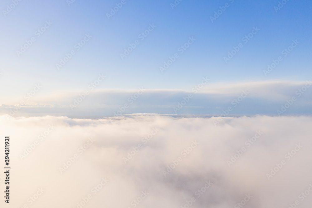 Obraz premium Aerial view white clouds in blue sky. Aerial top view cloudscape. Texture of clouds. View from above. Clouds texture background. Panorama clouds texture