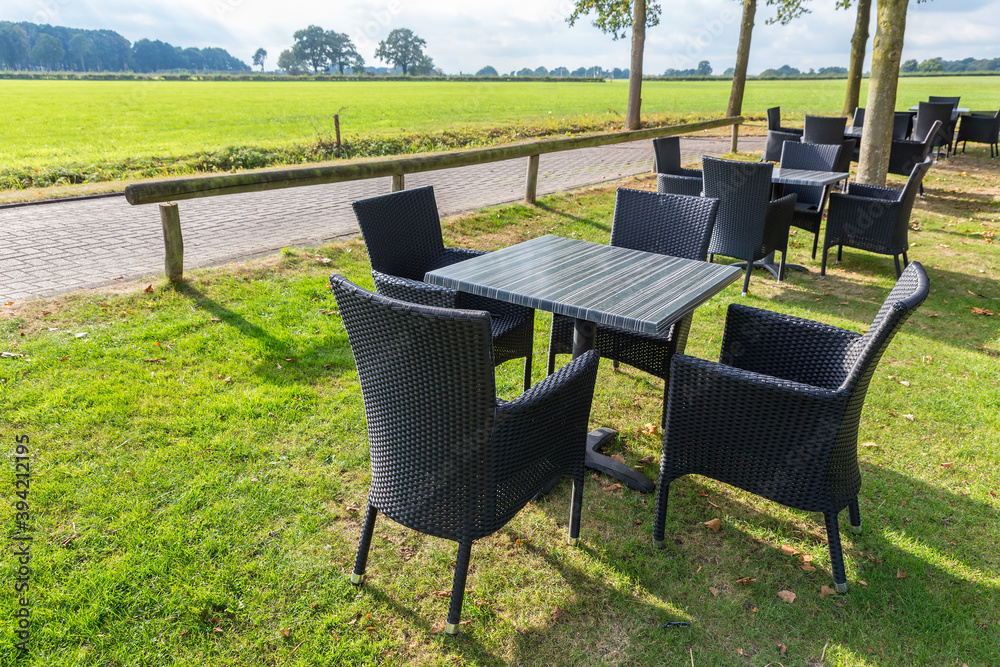 Group of tables and chairs outdoors in garden Group of tables and chairs outdoors in garden