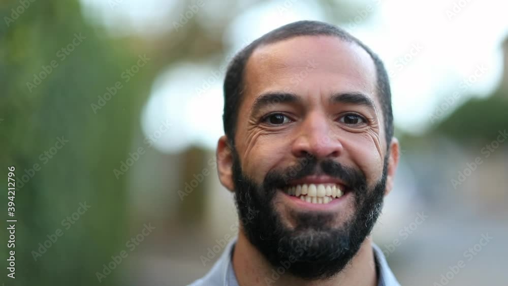 Happy hispanic man walking forward. Smiling multi-ethnic person portrait close-up face
