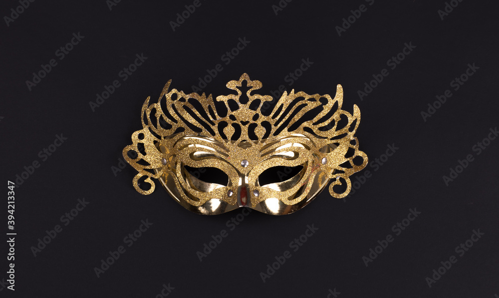 golden masquerade mask isolated on black background - obrazy, fototapety, plakaty 