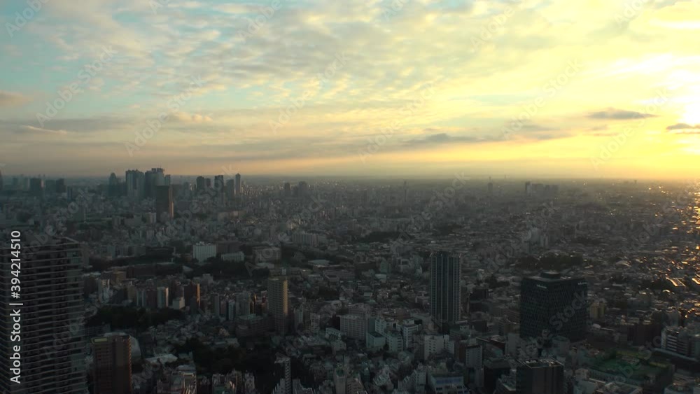 TOKYO, JAPAN : Aerial high angle sunset CITYSCAPE of TOKYO. View of buildings around Shinjuku and Nakano ward. Japanese urban metropolis and nature concept. Time lapse zoom out shot dusk to night. TOKYO, JAPAN : Aerial high angle sunset CITYSCAPE of TOKYO. View of buildings around Shinjuku and Nakano ward. Japanese urban metropolis and nature concept. Time lapse zoom out shot dusk to night.