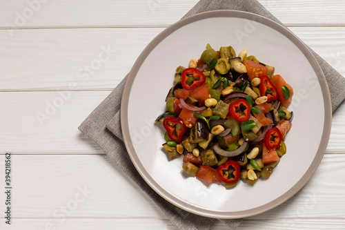 Wallpaper Mural Traditional Sicilian dish of eggplant caponata on a wooden table. Top view Torontodigital.ca