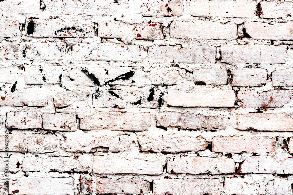 Texture of a brick wall with cracks and scratches which can be used as a background