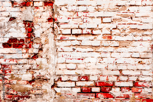 Texture of a brick wall with cracks and scratches which can be used as a background