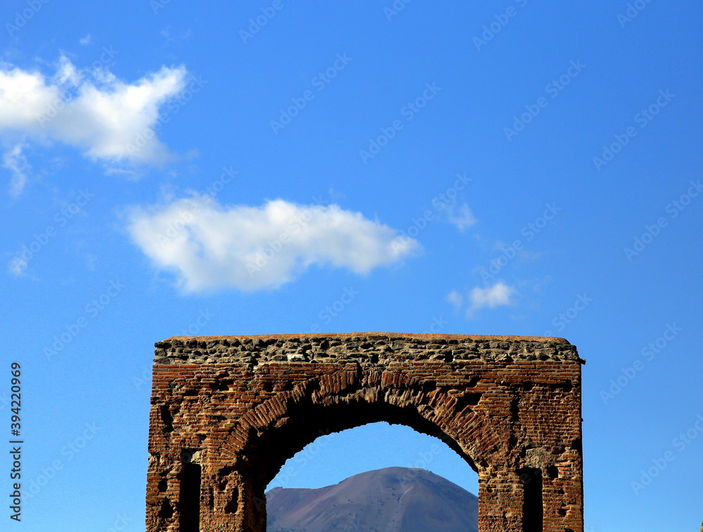 Top of the Vesuvius volcano framed by the Roman arch