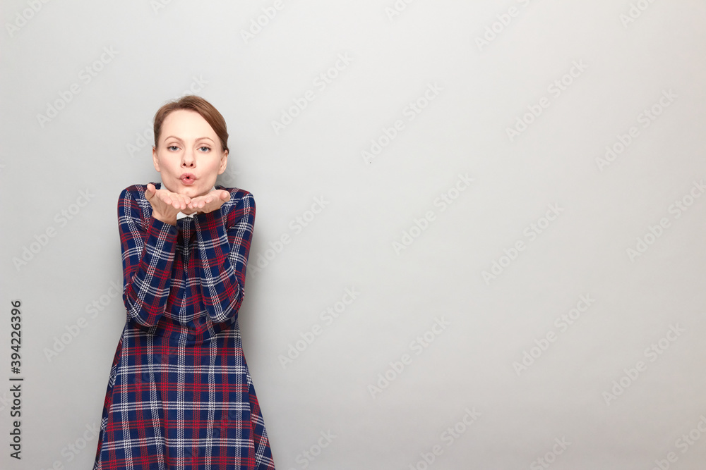 Portrait of romantic young woman blowing air kiss to you Portrait of romantic young woman blowing air kiss to you