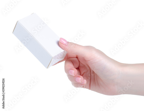 Small white box in hand on white background isolation
