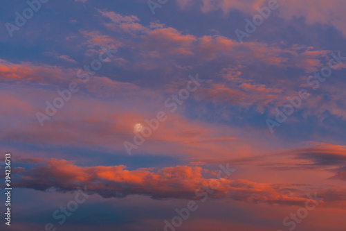 Wallpaper Mural Background of amazing mystery red and yellow clouds illuminated by rays of evening sun on blue sky at sunset. Telephoto lens photo shot Torontodigital.ca