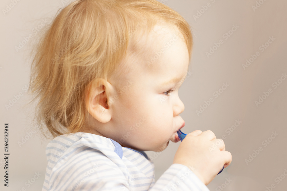little baby practicing brushing teeth on his own. Kid with red hair brushes teeth. Oral hygiene. little baby practicing brushing teeth on his own. Kid with red hair brushes teeth. Oral hygiene.