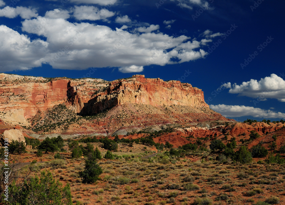 View To The Beautiful Landscape Of Capitol Reef National Park From Scenic Drive Road On A Sunny Summer Day With A Clear Blue Sky And A Few Clouds View To The Beautiful Landscape Of Capitol Reef National Park From Scenic Drive Road On A Sunny Summer Day With A Clear Blue Sky And A Few Clouds
