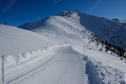 Freshly groomed ski run on the slope with Monte Elmo peak in background, Sexten Dolomites, Italy