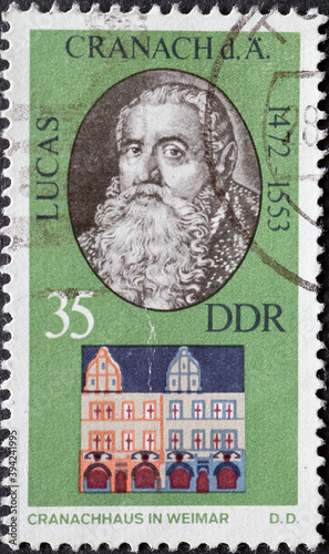 GERMANY, DDR - CIRCA 1973 : a postage stamp from Germany, GDR showing a portrait painter, graphic artist and printer Lucas Cranach the Elder with Cranachhaus in Weimar. Memorial in Weimar photo
