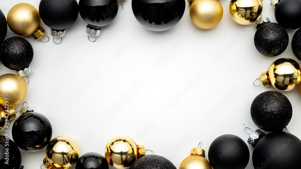 Holiday winter background. Gold Christmas baubles decoration on white background. Winter festive composition with copy space.