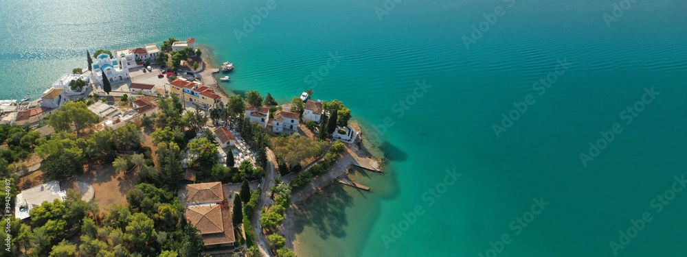 Obraz premium Aerial drone ultra wide panoramic photo of picturesque seaside village and bay of Porto Heli a safe anchorage for yachts and sailboats, Argolida, Peloponnese, Greece