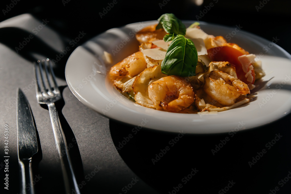 shrimp salad on a black background with beautiful shadows. Top view shrimp salad on a black background with beautiful shadows. Top view