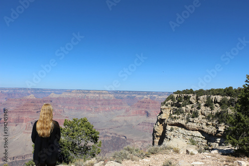 Young woman looks at the spectacular Grand canyon