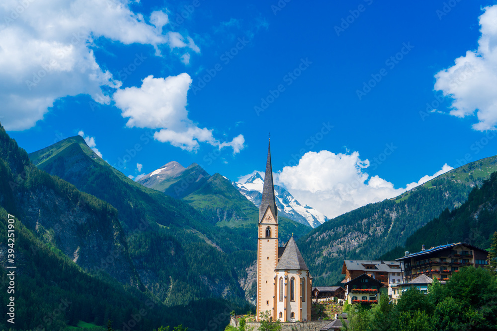 Little church in Heiligenblut, Austria, located in the valley, between Alpine mountains. Grossglockner group in the back.