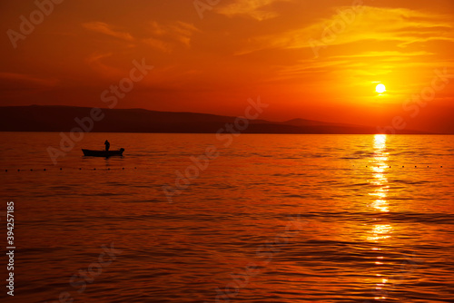 Image of a fishing boat against the sunset background © Rechitan Sorin