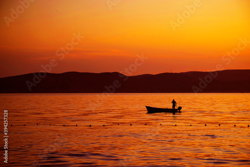 Image of a fishing boat against the sunset background