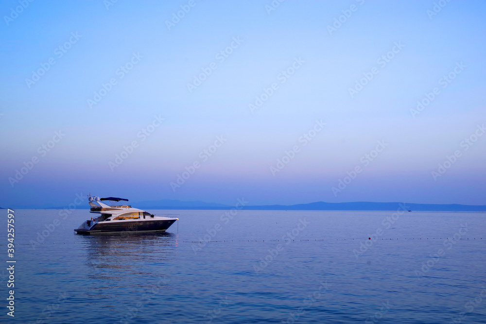 Naklejka premium Image of a luxurious yacht on the ocean. Sunset colours.