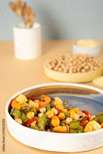 Homemade vegetarian stewed chick-pea chickpeas with vegetables. Style minimalism. Selective focus. On plate bowl close up. Concept healthy vegan diet protein organic food dish