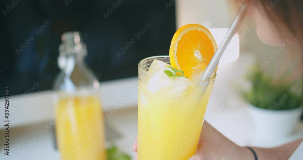 young woman drinking Juicy fresh orange juice with straw, healthy lifestyle refreshment summer concept