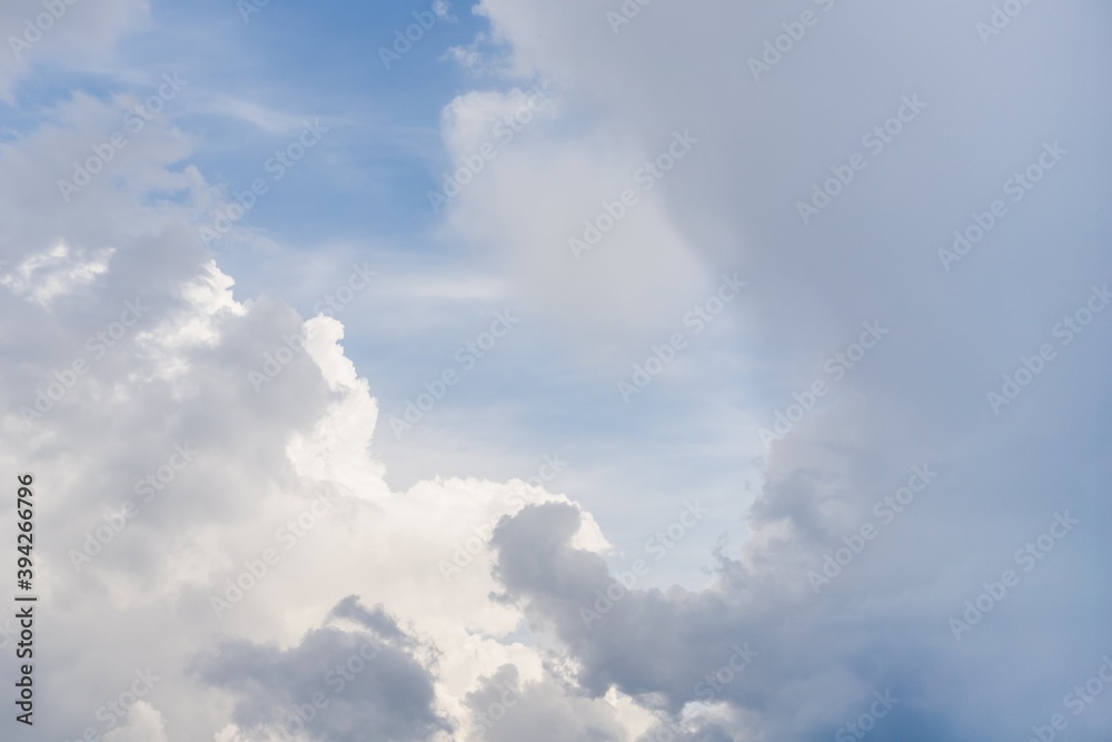 Light blue sky with natural white fluffy clouds