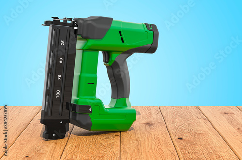 Electric Brad Nailer on the wooden planks, 3D rendering