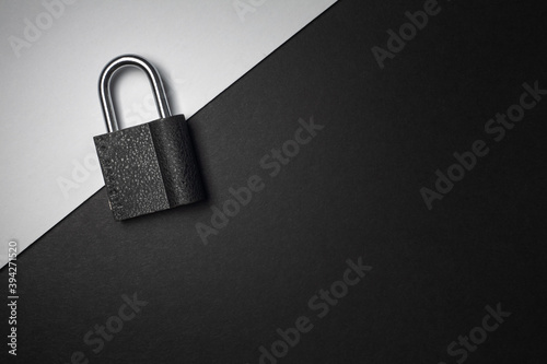 Locked padlock on a two tone black & white simple background. Security cyber secure safety locked 