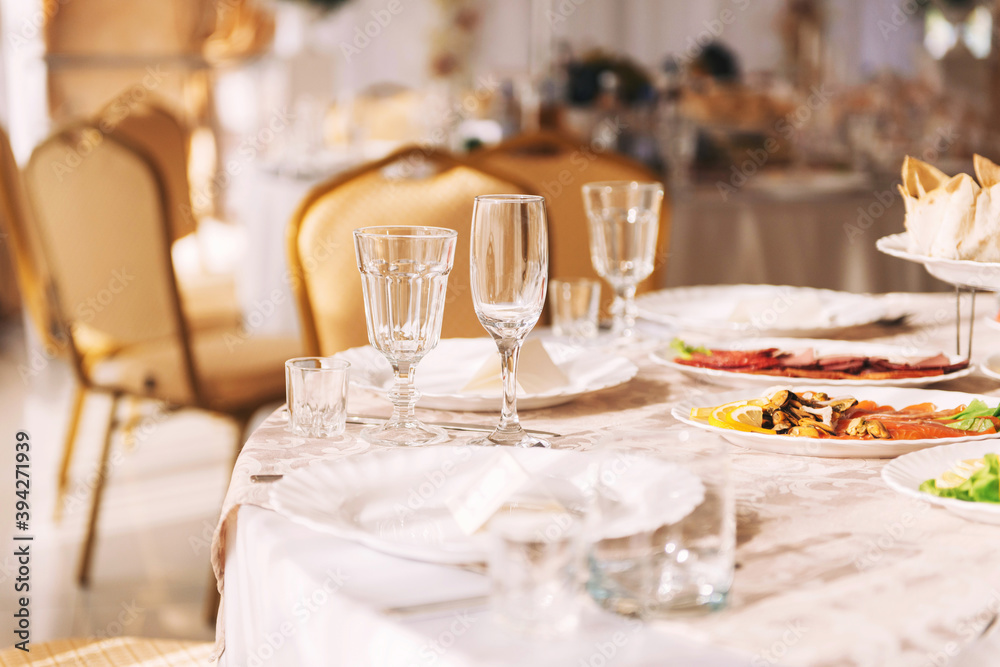 Table setting at a banquet, beautiful dishes, glasses